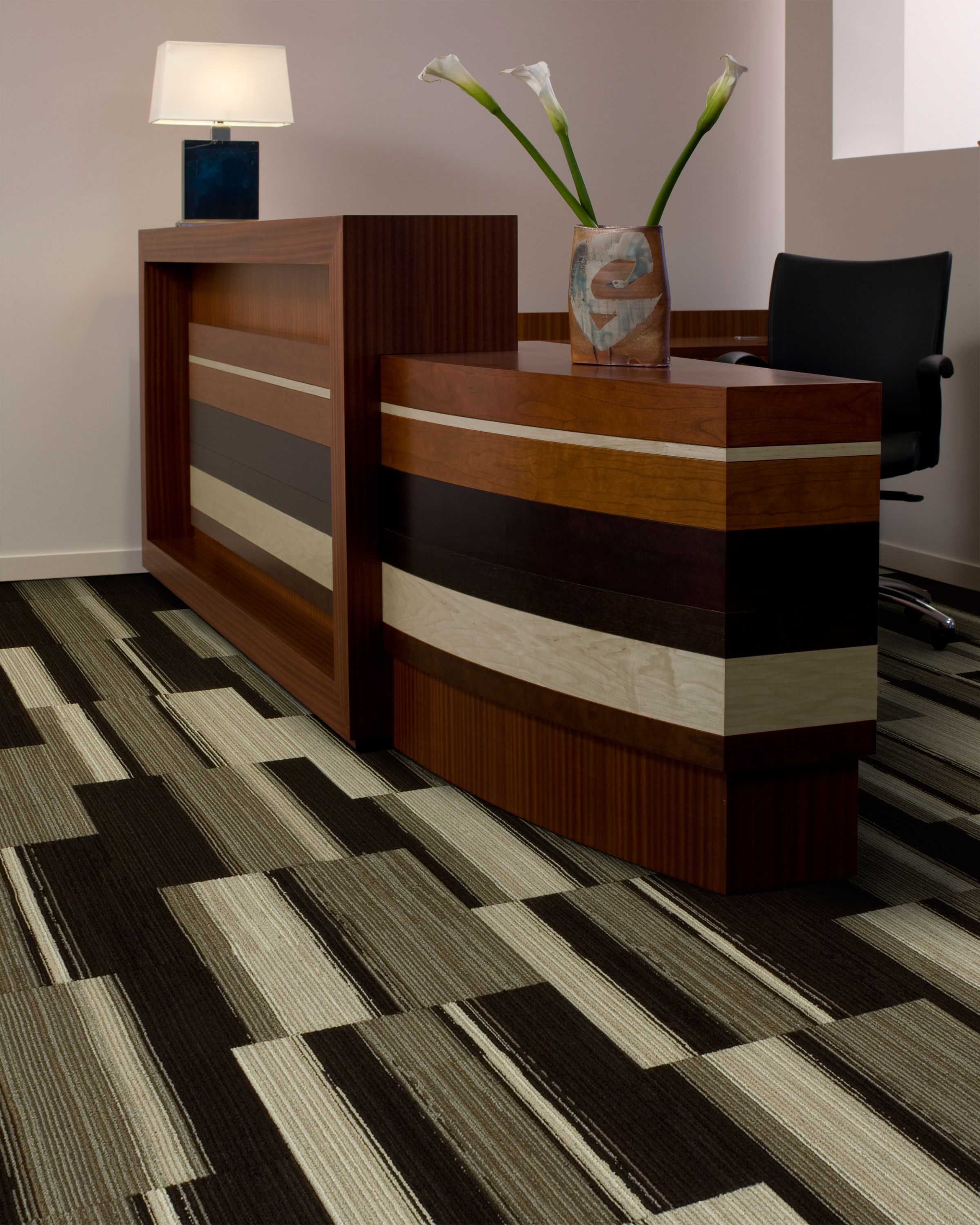 Interface Across the Board carpet tile in reception area with wood desk and Calla lillies image number 5